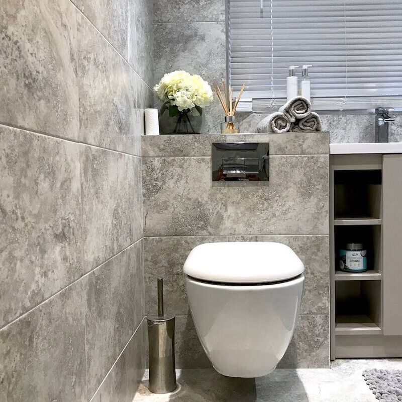 A gorgeous bathroom with a marble surround and chrome accessories in a luxurious bathroom renovation in St Albans