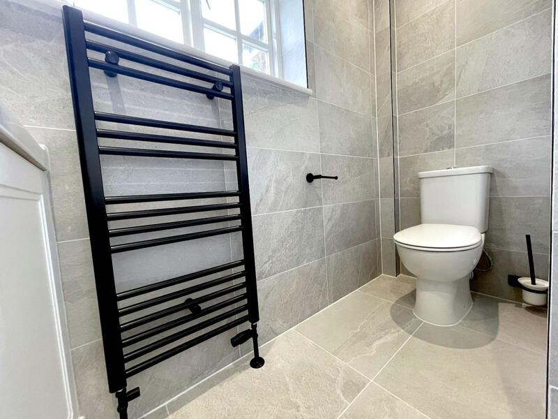 Stylish black towel rail and modern grey tiles in St Albans bathroom renovation