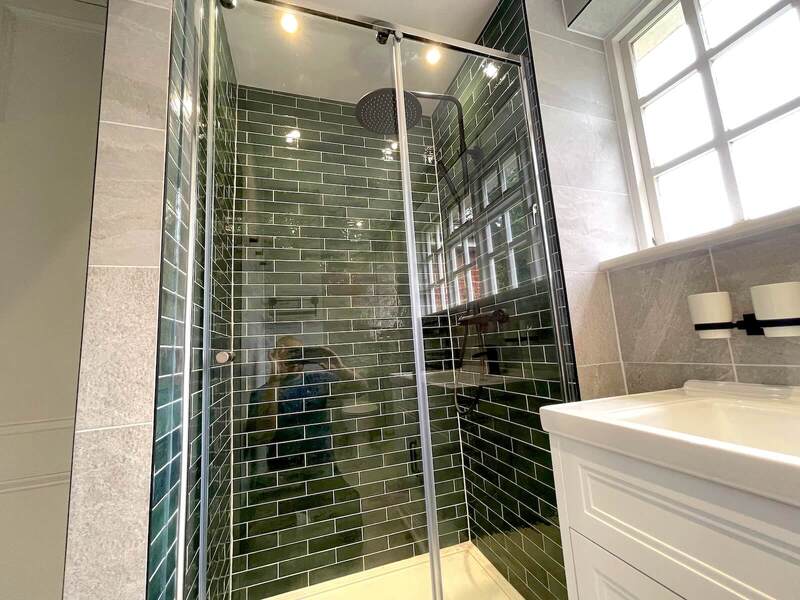 Green tiled shower in St Albans bathroom renovation.
Close-up of green tiles and showerhead in St Albans bathroom.

Fully renovated bathroom with green tiles and modern fixtures in St Albans.