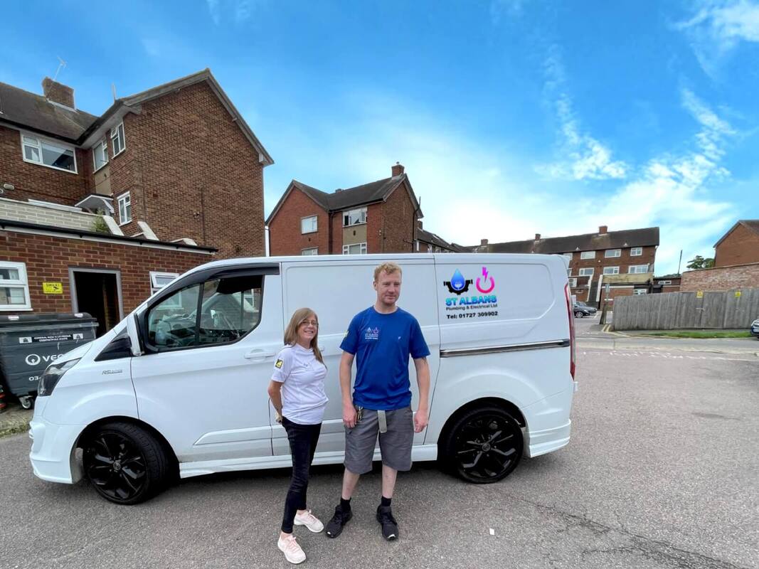 Staff from St Albans plumbing & electrical ltd standing in from of company van in 2024